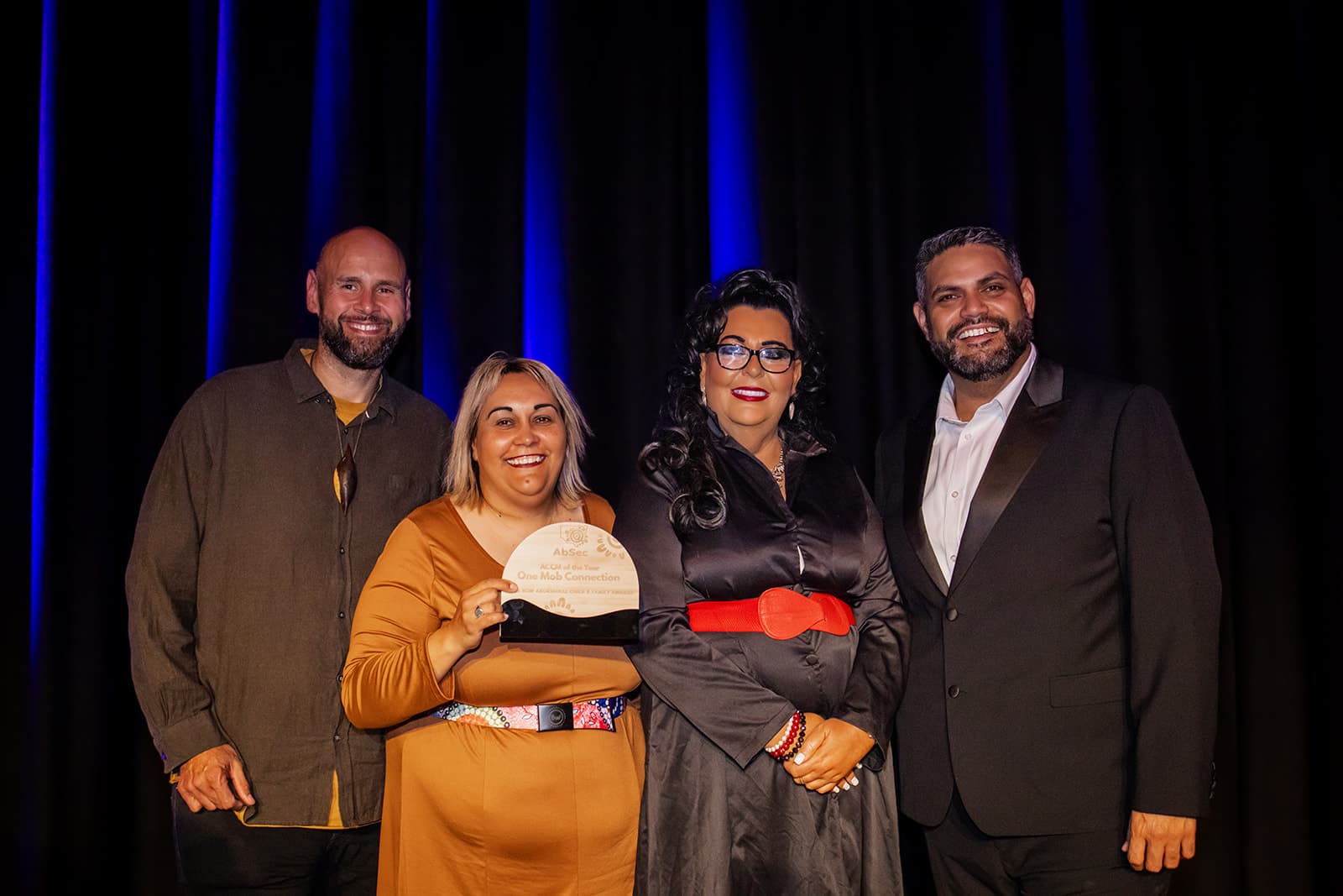 A recipient accepting her award on stage