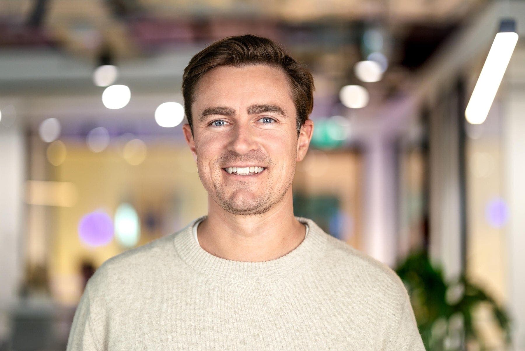 Corporate headshot of a young man on a light background