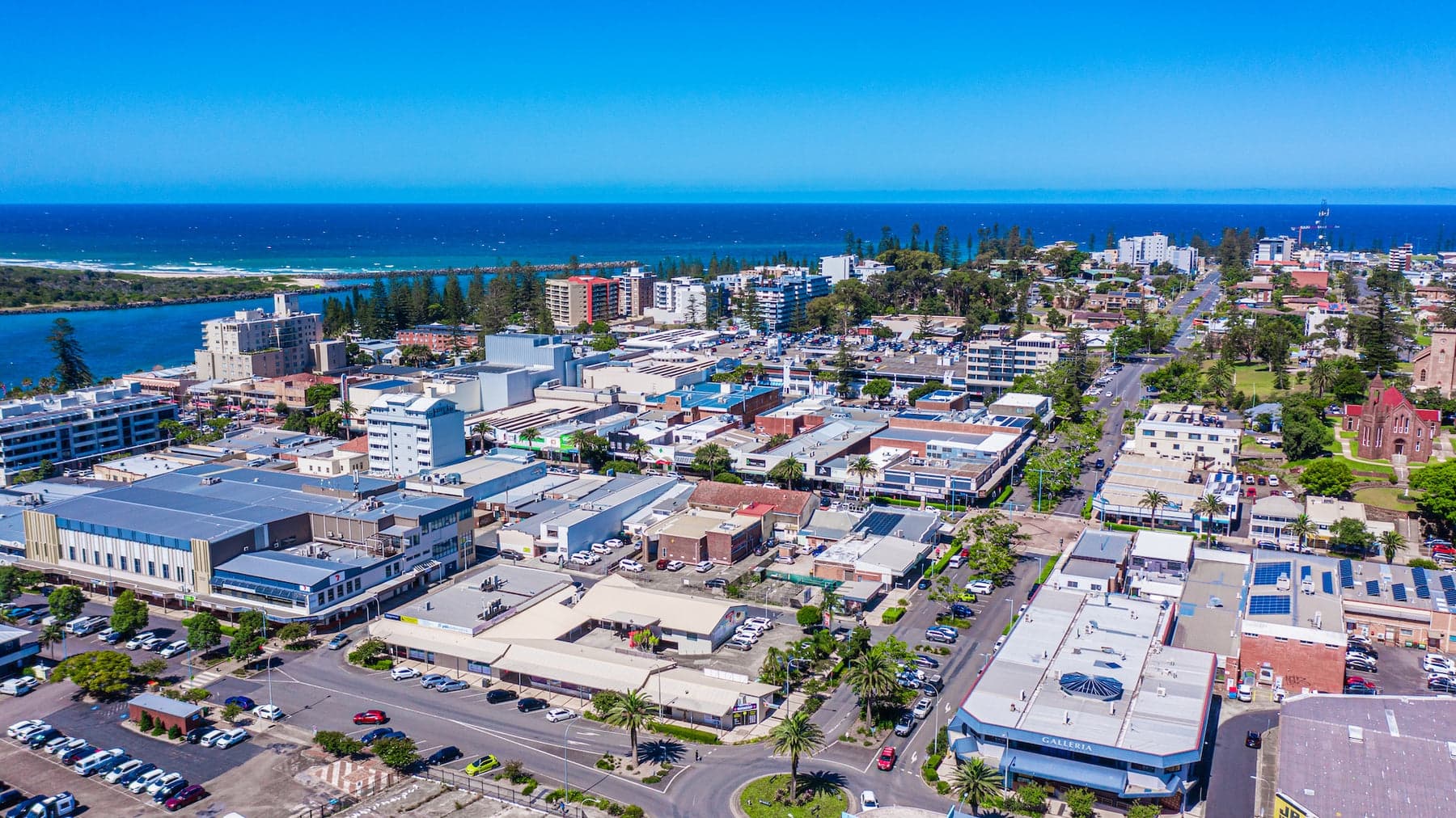Aerial of Port Macquarie town centre with the river mouth and ocean beyond