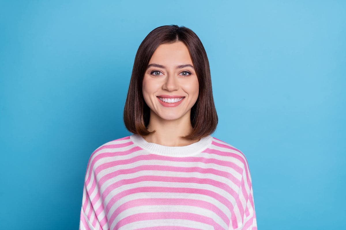 Headshot on a sky blue studio backdrop