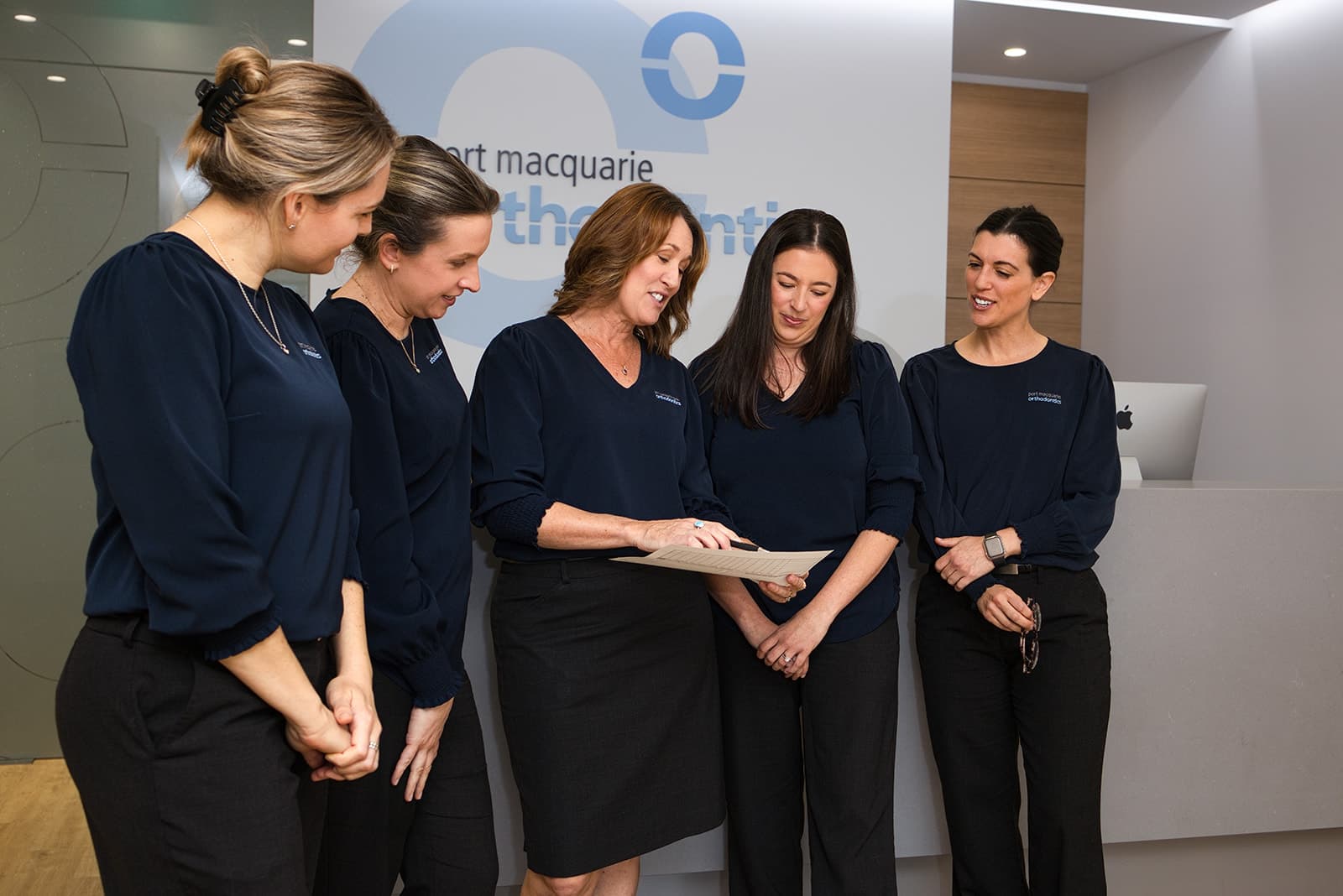 Reception team reviewing paperwork together