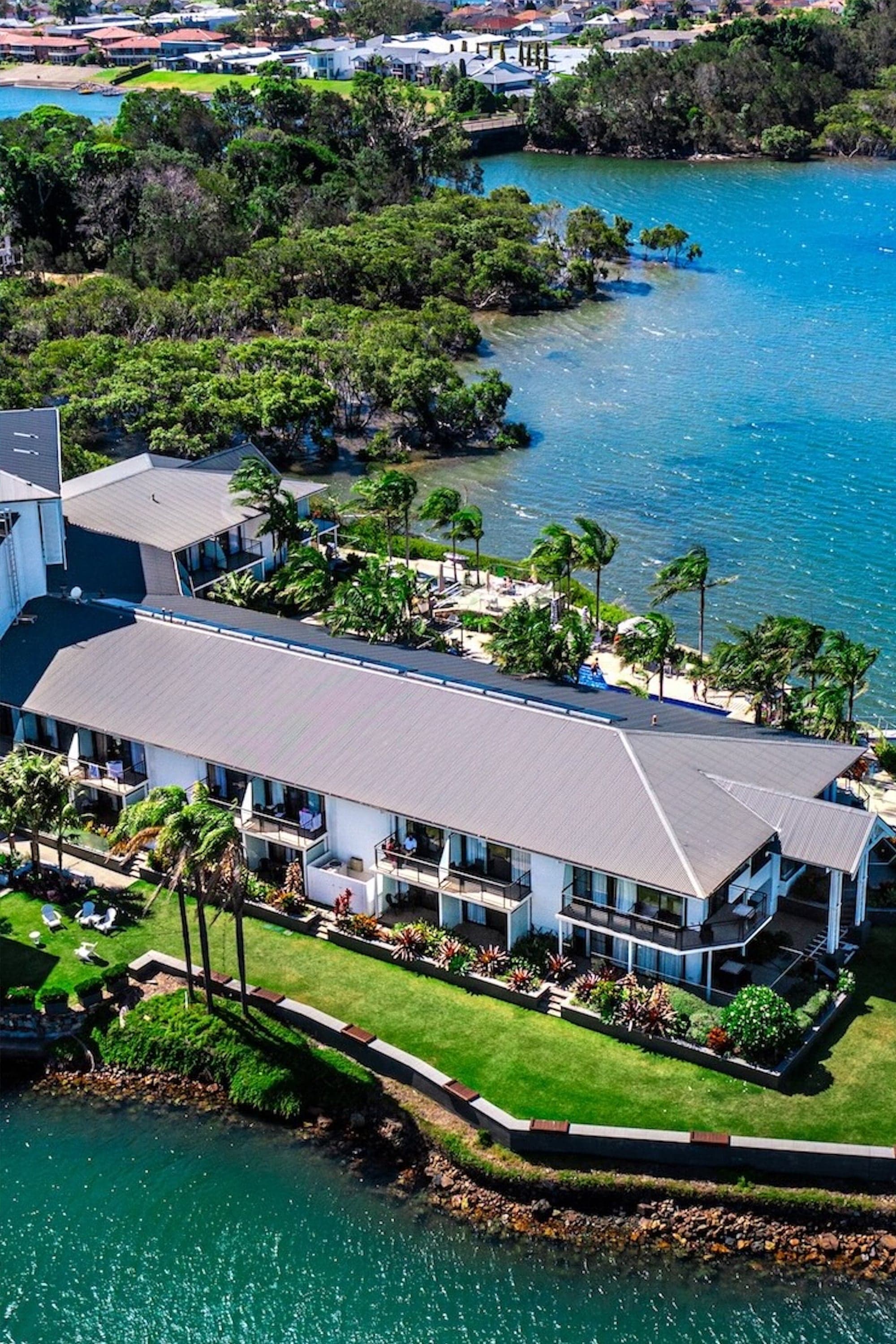 Aerial of a waterfront resort surrounded by palms