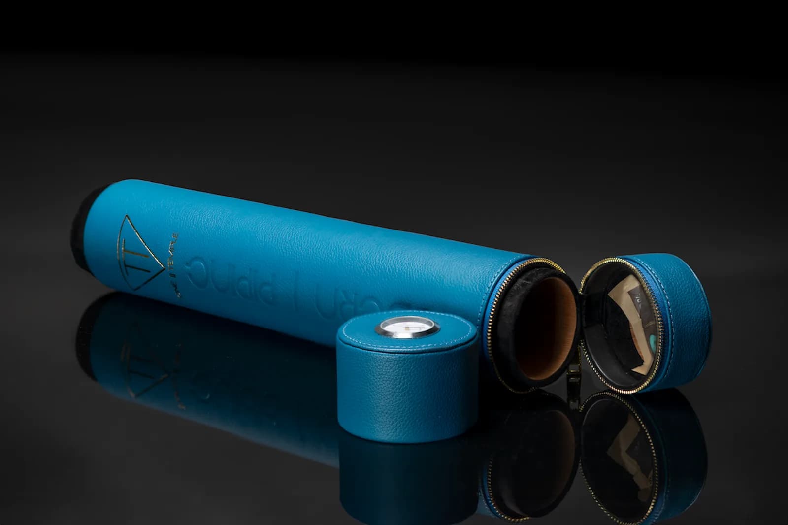 Teal leather case opened to show its fitted cap