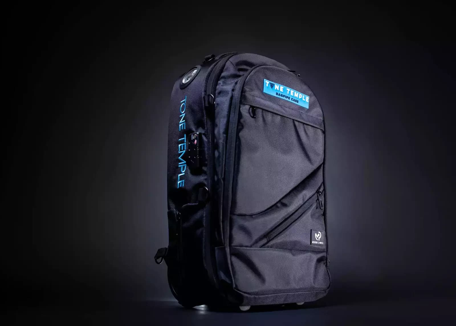 Black backpack lit against a deep blue backdrop