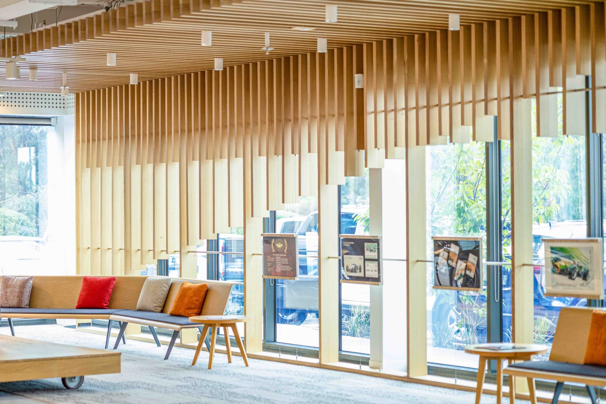 Commercial lobby with a timber slat ceiling and window bench seating